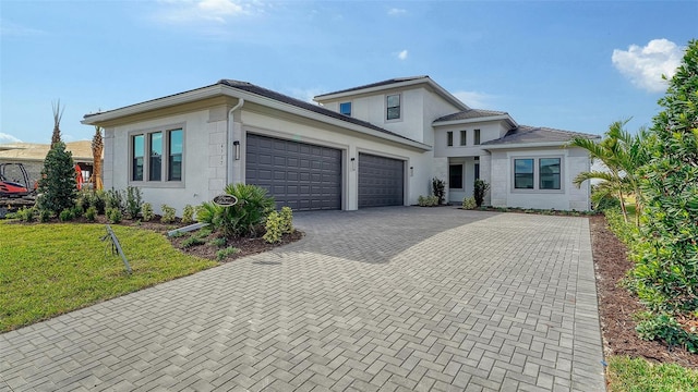 view of front of house featuring a garage and a front lawn