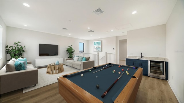 rec room with pool table, hardwood / wood-style flooring, wine cooler, and wet bar