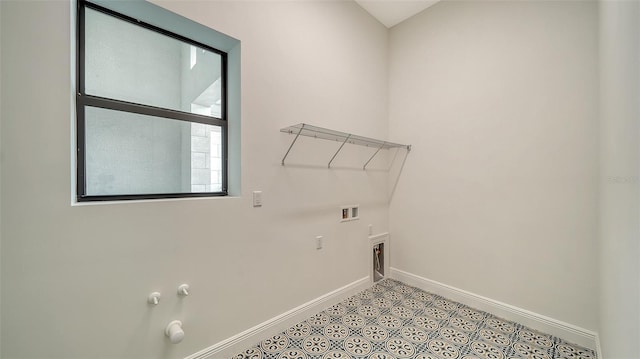 washroom featuring light tile patterned flooring, hookup for a gas dryer, and washer hookup