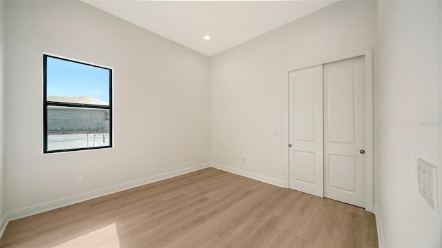 unfurnished bedroom featuring a closet and light hardwood / wood-style flooring