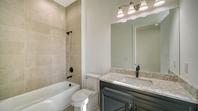 full bathroom featuring toilet, tiled shower / bath combo, and vanity