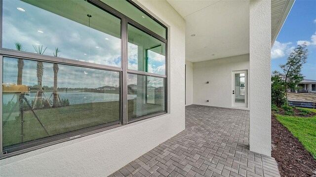 exterior space featuring a water view and a patio