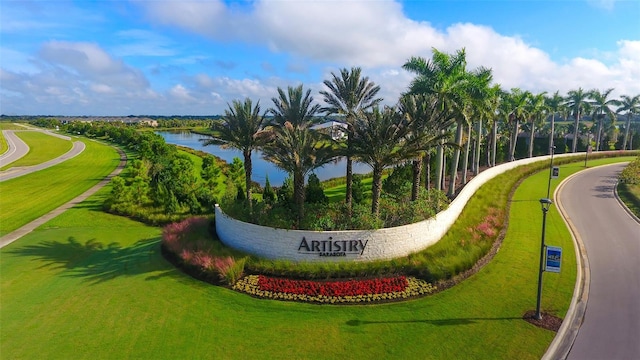 view of property's community featuring a yard and a water view