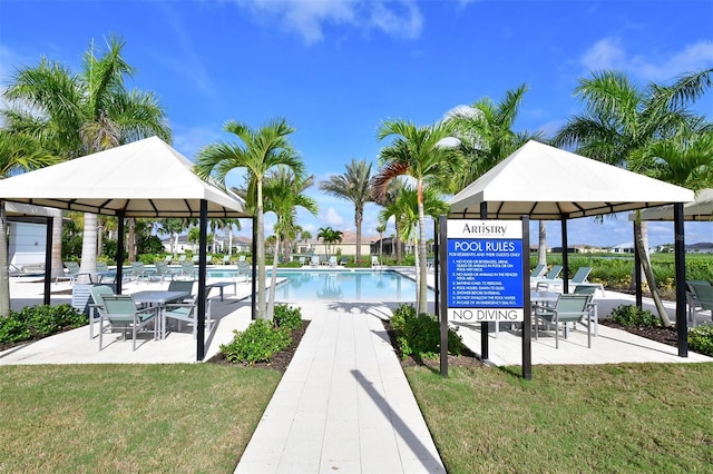 view of swimming pool with a yard and a gazebo