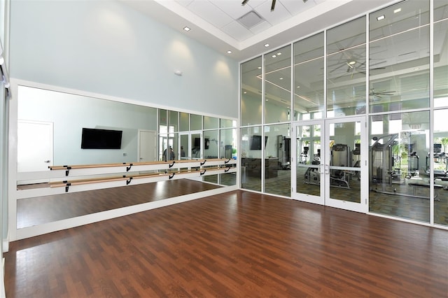 interior space with a high ceiling, wood-type flooring, and floor to ceiling windows