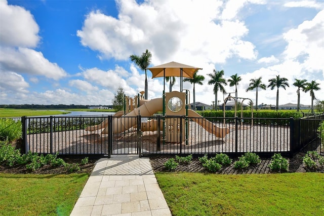 view of jungle gym with a water view and a lawn