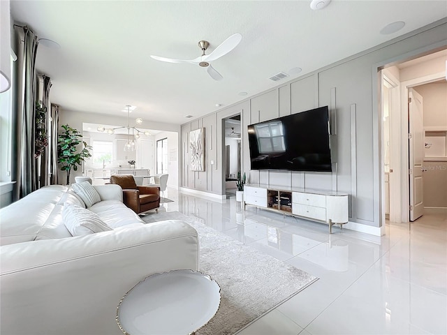 living room with ceiling fan and light tile patterned floors