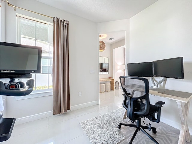 office featuring light tile patterned floors and a textured ceiling