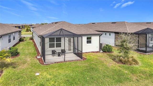 back of house featuring a yard, a patio, a lanai, and central air condition unit