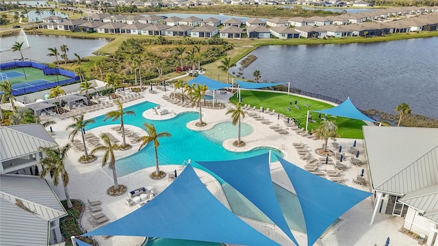 view of pool featuring a water view and a patio area