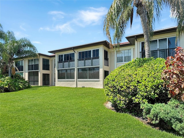 rear view of property with a yard