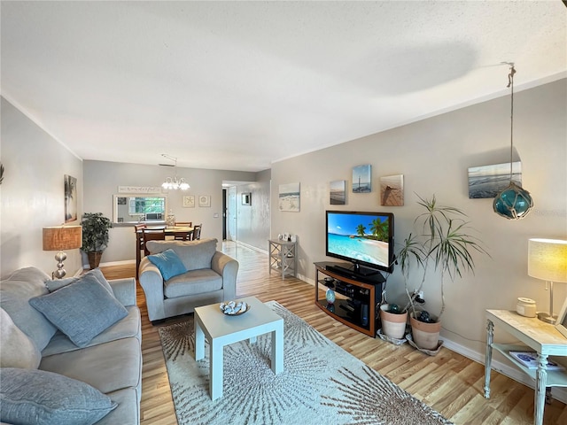 living room with light hardwood / wood-style flooring and a chandelier