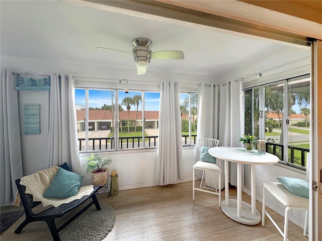 sunroom featuring ceiling fan