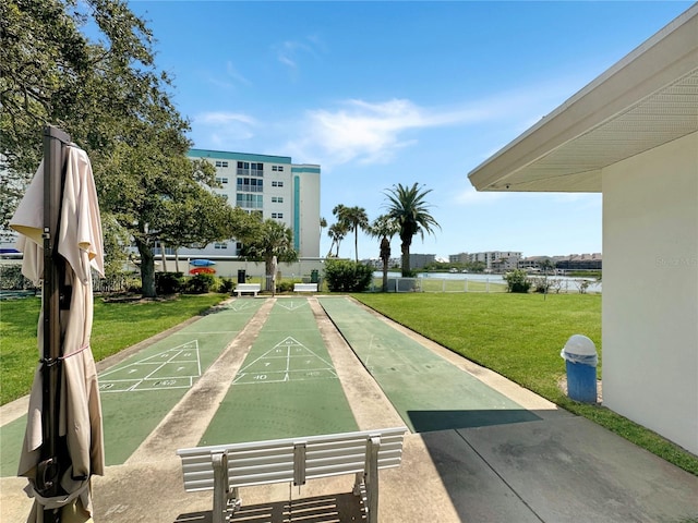 view of community with a lawn and a water view