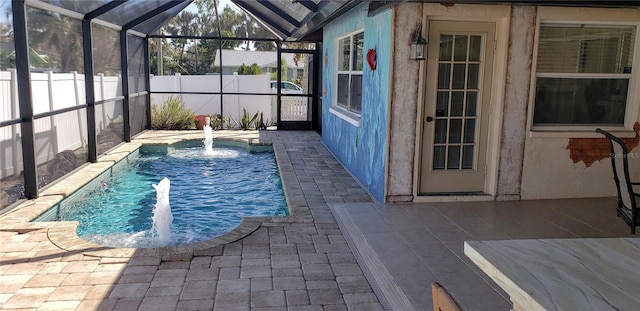 view of swimming pool featuring a patio, a lanai, and pool water feature