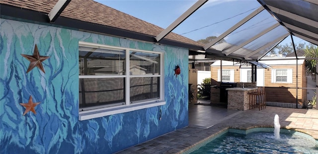 view of property exterior with a lanai, an outdoor bar, and a patio