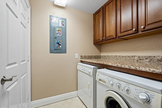 clothes washing area featuring cabinets, a textured ceiling, independent washer and dryer, and light tile patterned flooring