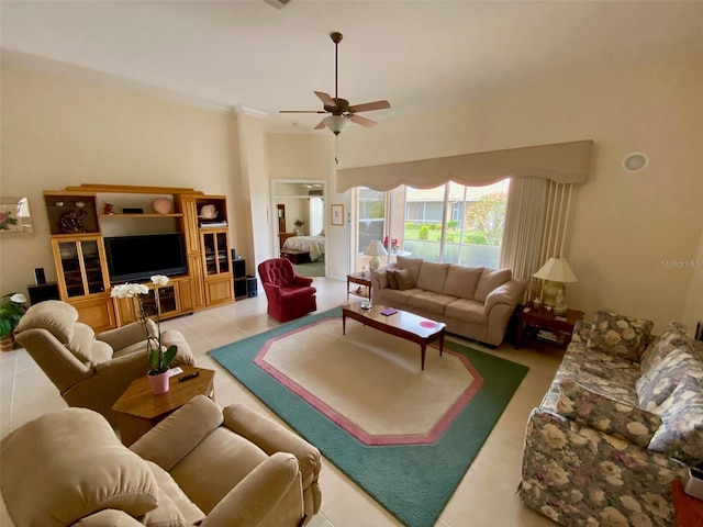 living room featuring ceiling fan, ornamental molding, and light tile patterned floors