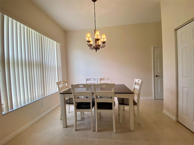 dining space featuring an inviting chandelier and light tile patterned floors