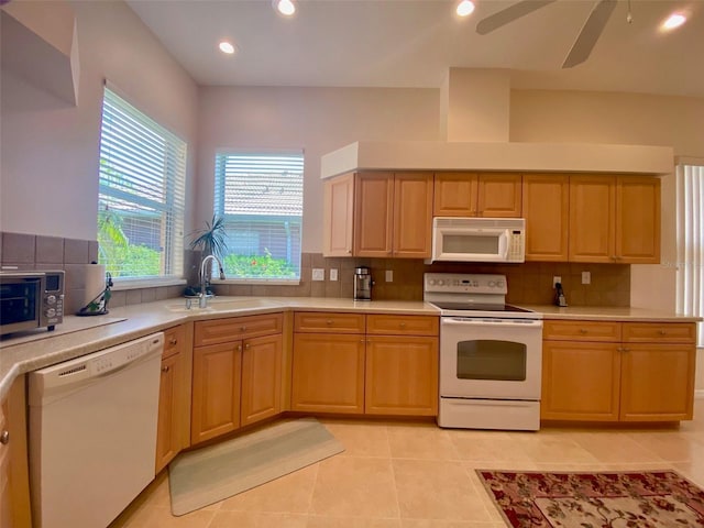 kitchen with white appliances, light tile patterned floors, backsplash, ceiling fan, and sink