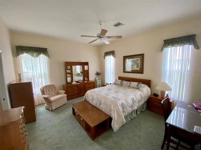 bedroom with multiple windows, carpet floors, and ceiling fan