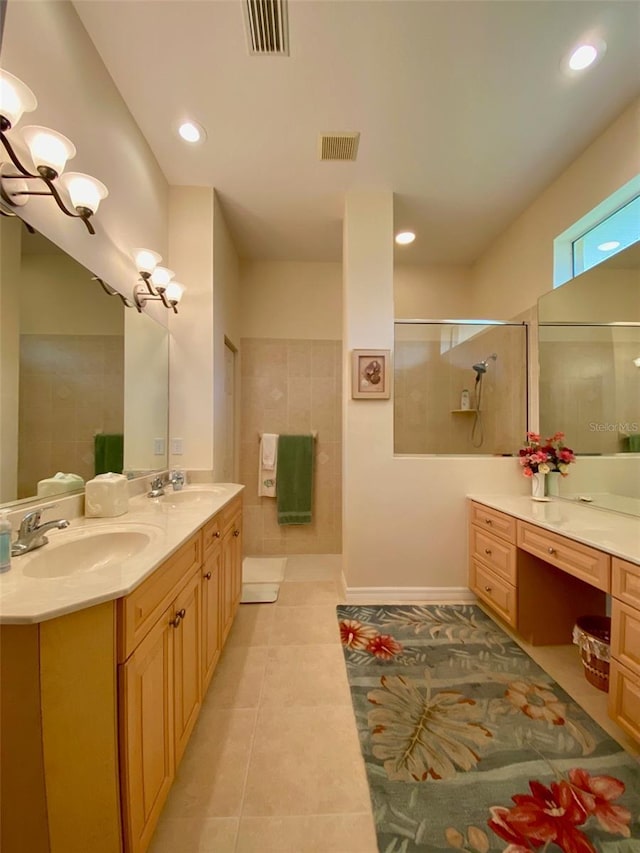 bathroom featuring tiled shower, tile patterned floors, and vanity