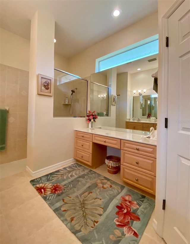 bathroom with tile patterned flooring, walk in shower, and vanity