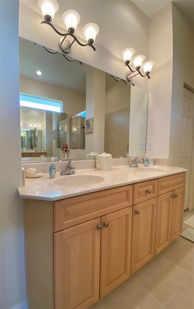 bathroom featuring vanity, walk in shower, and a notable chandelier