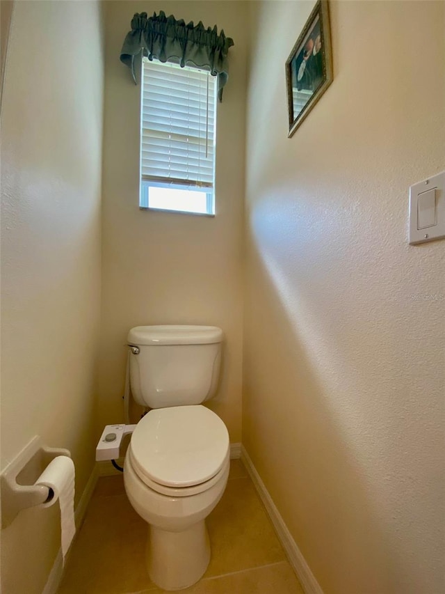 bathroom featuring toilet and tile patterned flooring