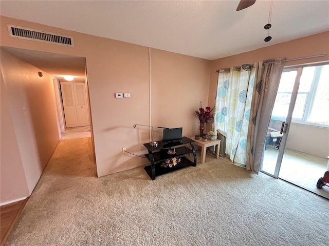 sitting room featuring light colored carpet