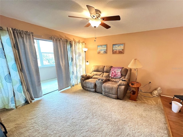 carpeted living room featuring ceiling fan