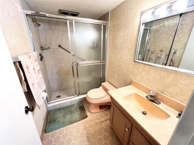 bathroom with tile patterned floors, a textured ceiling, an enclosed shower, toilet, and vanity