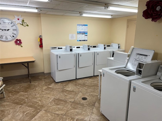 clothes washing area with washing machine and dryer