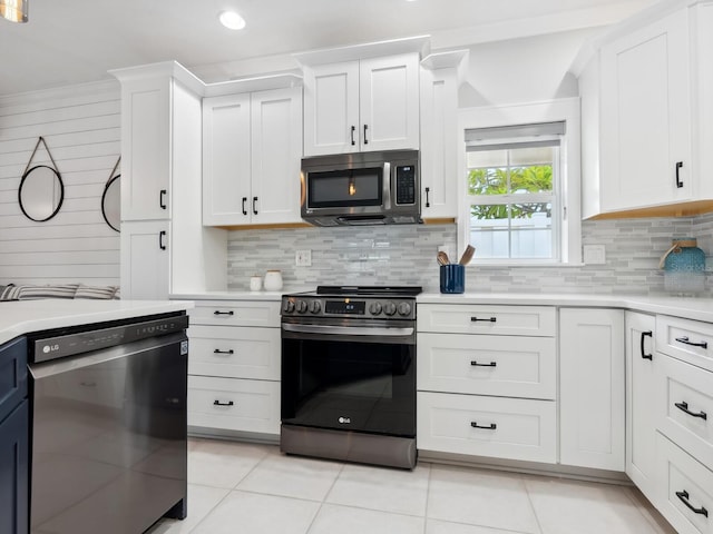 kitchen with black appliances, white cabinetry, backsplash, and light tile patterned floors