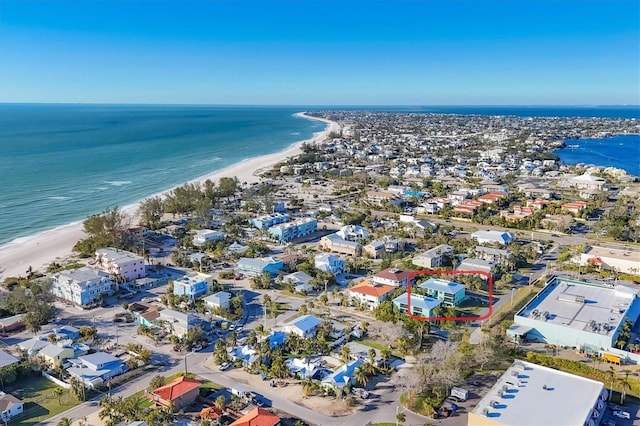 birds eye view of property with a water view and a view of the beach