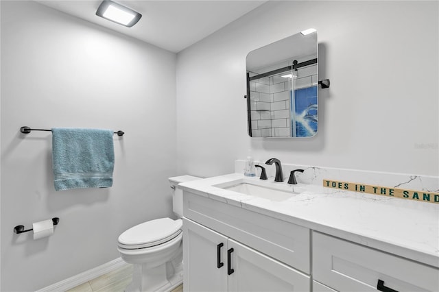 bathroom featuring toilet and vanity