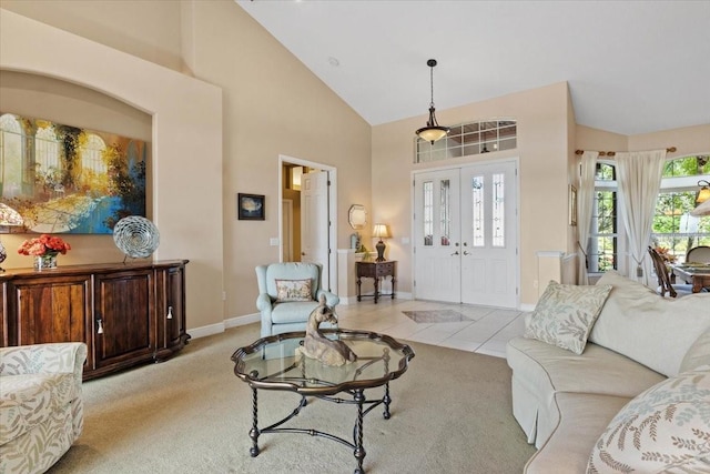 carpeted living room featuring high vaulted ceiling