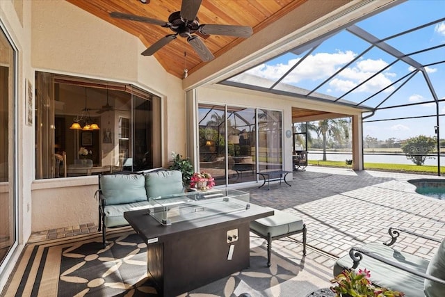 view of patio with glass enclosure and ceiling fan