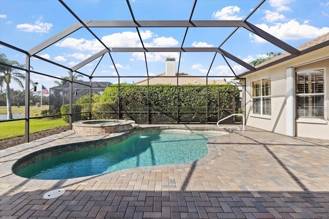 view of swimming pool with a lanai, a patio area, and an in ground hot tub