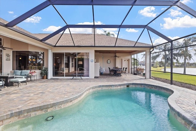 view of pool featuring ceiling fan, an outdoor living space, a patio, and glass enclosure