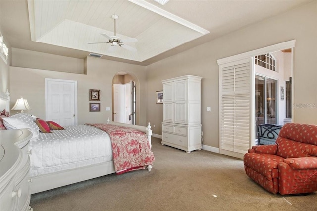 2611 Little Country Rd, Parrish, FL 34219 - bedroom with a ceiling fan, visible vents, arched walkways, light carpet, and a tray ceiling