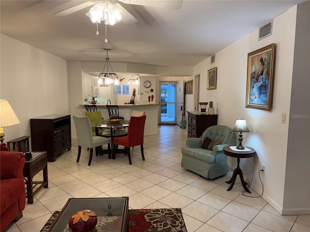 living room with ceiling fan with notable chandelier and light tile patterned flooring