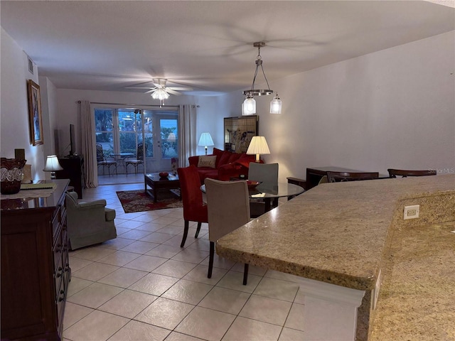 dining area with ceiling fan and light tile patterned flooring