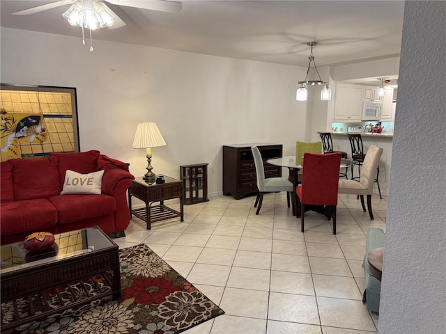 tiled living room with ceiling fan