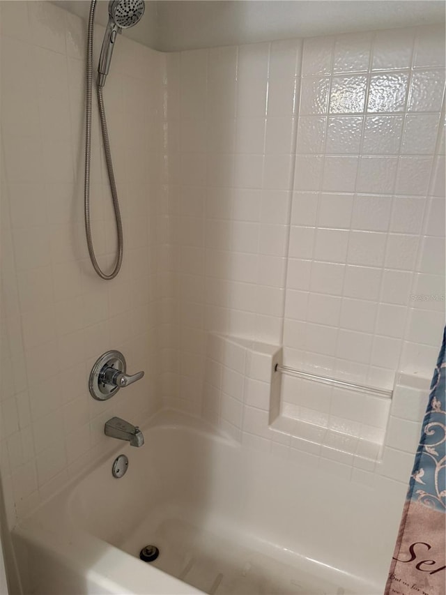 bathroom with shower / bath combo with shower curtain