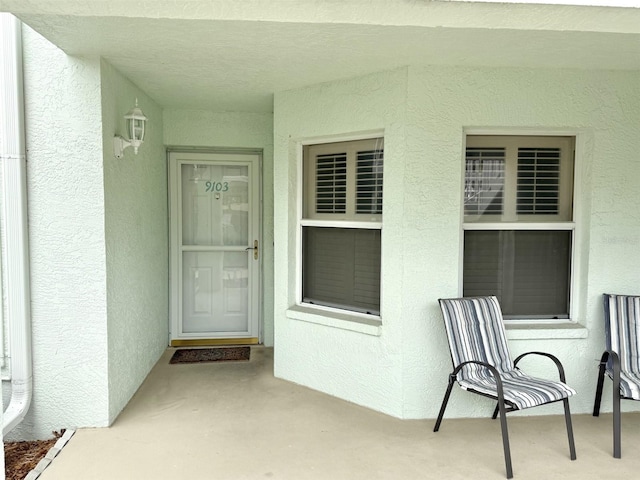 doorway to property featuring a patio