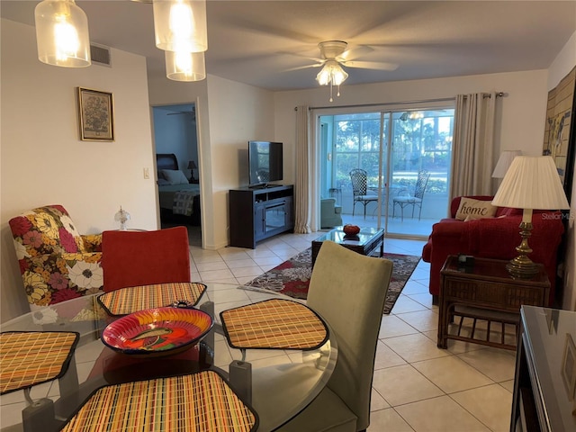 living room featuring ceiling fan and light tile patterned floors