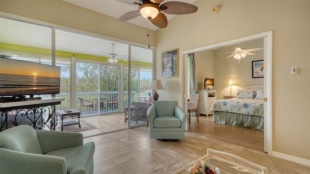 bedroom featuring access to exterior, light tile patterned floors, and ceiling fan