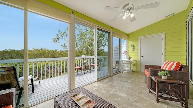 sunroom featuring lofted ceiling and ceiling fan