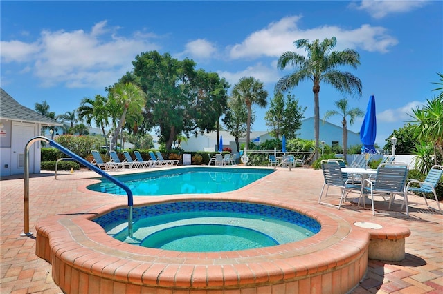 view of pool with a community hot tub and a patio area